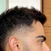 Virat Kohli shows off his new hairstyle done by Aalim Hakim during RCB Vs  MI match