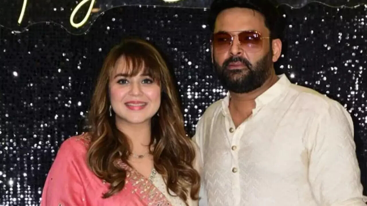 Kapil: Kapil Sharma kisses wife Ginni Chatrath as they pose for the ...